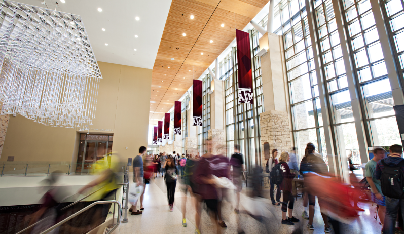 people in motion walking through the Memorial Student Center at Texas A&M University